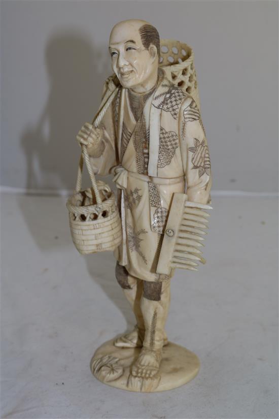 A Japanese sectional ivory figure of a fisherman, early 20th century, 23.5cm